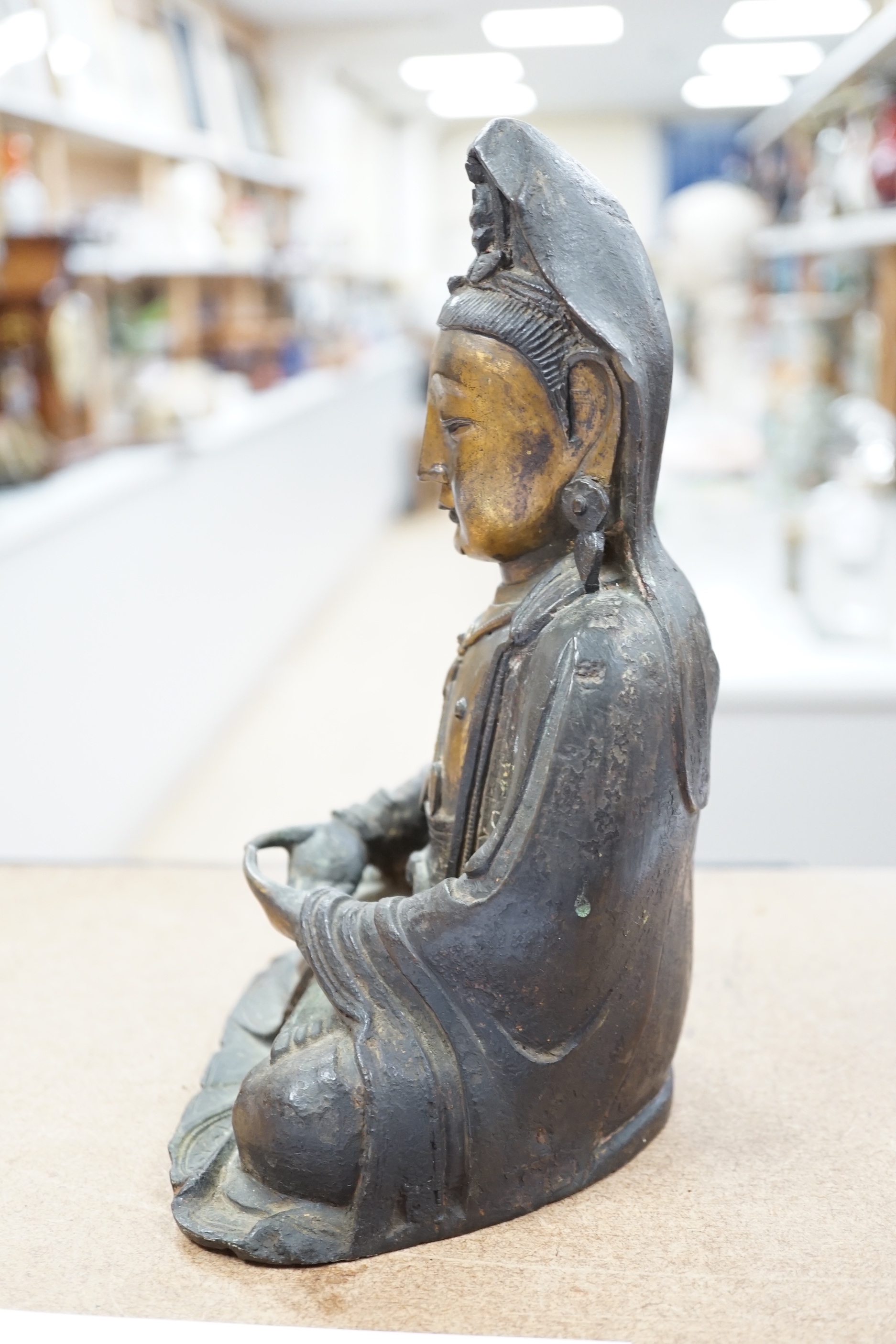 A Chinese Ming gilt bronze figure of Xi Wangmu, Queen Mother of the West, late 16th / early 17th century, Provenance: bought from the 50th Chelsea Antiques Fair, R & D Coombes, 1980, 24cm high